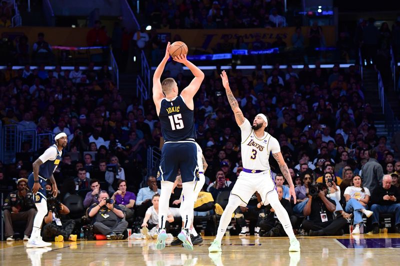 LOS ANGELES, CA - APRIL 27: Nikola Jokic #15 of the Denver Nuggets shoots a three point basket against the Los Angeles Lakers during Round 1 Game 4 of the 2024 NBA Playoffs on April 27, 2024 at Crypto.Com Arena in Los Angeles, California. NOTE TO USER: User expressly acknowledges and agrees that, by downloading and/or using this Photograph, user is consenting to the terms and conditions of the Getty Images License Agreement. Mandatory Copyright Notice: Copyright 2024 NBAE (Photo by Adam Pantozzi/NBAE via Getty Images)