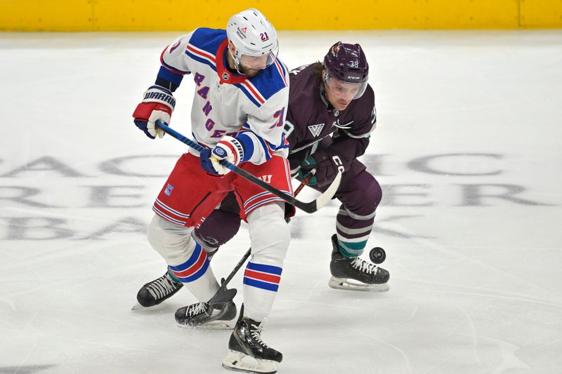 Jan 21, 2024; Anaheim, California, USA; New York Rangers center Barclay Goodrow (21) and Anaheim Ducks center Sam Carrick (39) battle for the puck in the first period at Honda Center. Mandatory Credit: Jayne Kamin-Oncea-USA TODAY Sports