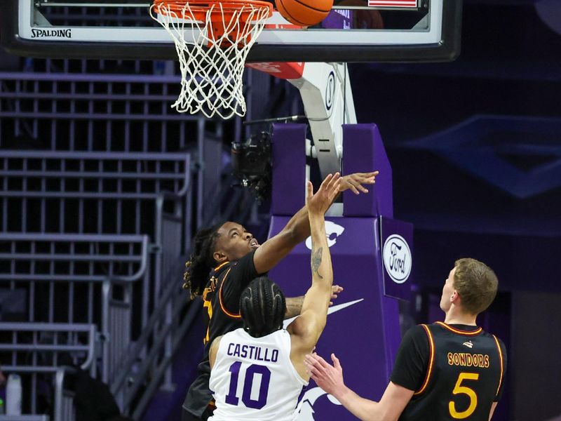 Dec 28, 2025; Manhattan, Kansas, USA; Kansas State Wildcats guard David Castillo (10) shoots against Louisiana-Monroe Warhawks forward Renars Sondors (5) and guard MJ Russell (21) during the first half at Bramlage Coliseum. Mandatory Credit: Scott Sewell-Imagn Images