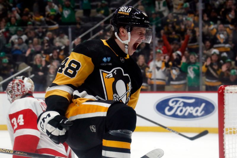 Mar 17, 2024; Pittsburgh, Pennsylvania, USA;  Pittsburgh Penguins right wing Valtteri Puustinen (48) reacts after scoring a goal against Detroit Red Wings goaltender Alex Lyon (34) during the first period at PPG Paints Arena. Mandatory Credit: Charles LeClaire-USA TODAY Sports