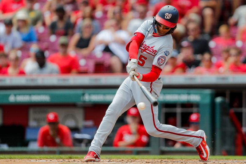 Aug 6, 2023; Cincinnati, Ohio, USA; Washington Nationals shortstop CJ Abrams (5) hits a single against the Cincinnati Reds in the second inning at Great American Ball Park. Mandatory Credit: Katie Stratman-USA TODAY Sports