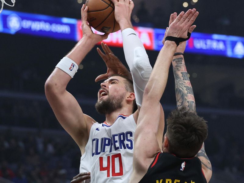 LOS ANGELES, CALIFORNIA - MARCH 17: Ivica Zubac #40 of the LA Clippers reacts as he is fouled on his shot in front of Vit Krejci #27 of the Atlanta Hawks during the first half at Crypto.com Arena on March 17, 2024 in Los Angeles, California. (Photo by Harry How/Getty Images) User is consenting to the terms and conditions of the Getty Images License Agreement.  (Photo by Harry How/Getty Images)