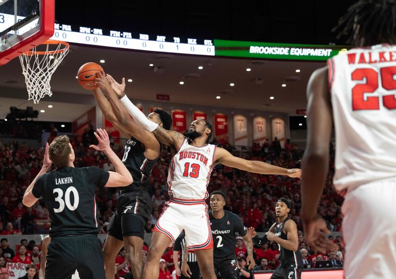 Jan 28, 2023; Houston, Texas, USA; Houston Cougars forward J'Wan Roberts (13) and Cincinnati Bearcats guard Josh Reed (13) reach for a rebound in the first half at Fertitta Center. Mandatory Credit: Thomas Shea-USA TODAY Sports