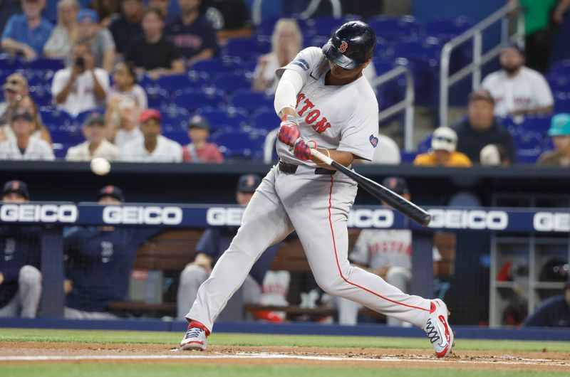 Jul 2, 2024; Miami, Florida, USA;  Boston Red Sox third baseman Rafael Devers (11) singles in two runs against the Miami Marlins in the first inning at loanDepot Park. Mandatory Credit: Rhona Wise-USA TODAY Sports