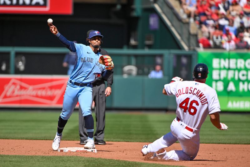 Apr 2, 2023; St. Louis, Missouri, USA;  Toronto Blue Jays second baseman Santiago Espinal (5) turns a double play as St. Louis Cardinals first baseman Paul Goldschmidt (46) slides during the fourth inning at Busch Stadium. Mandatory Credit: Jeff Curry-USA TODAY Sports