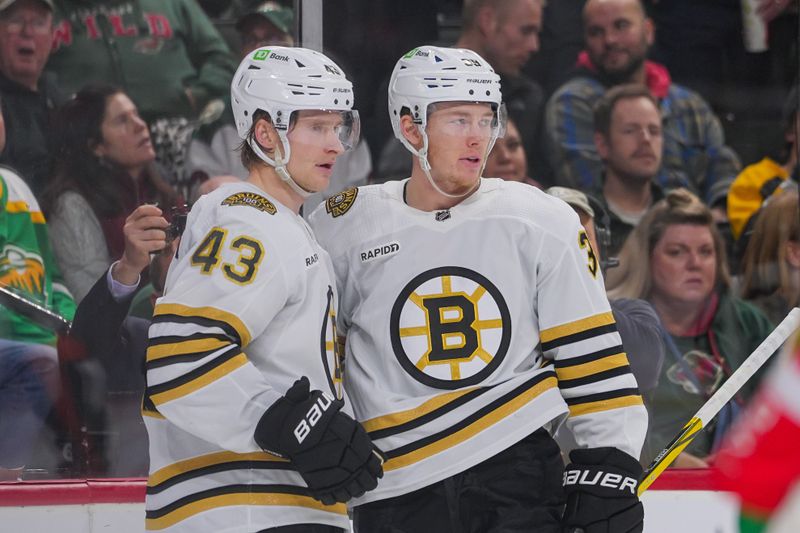 Dec 23, 2023; Saint Paul, Minnesota, USA; Boston Bruins center Morgan Geekie (39) celebrates his goal with left wing Danton Heinen (43) against the Minnesota Wild in the third period at Xcel Energy Center. Mandatory Credit: Brad Rempel-USA TODAY Sports