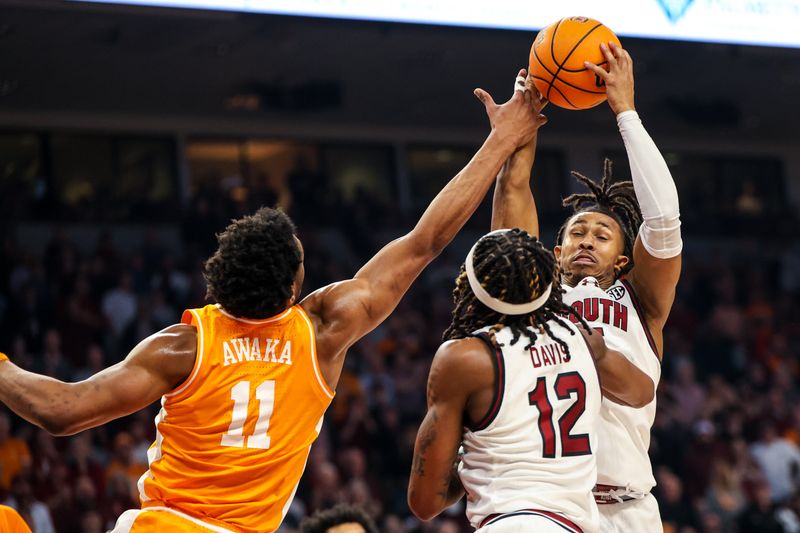 Mar 6, 2024; Columbia, South Carolina, USA; South Carolina Gamecocks guard Meechie Johnson (5) grabs a rebound over Tennessee Volunteers forward Tobe Awaka (11) in the first half at Colonial Life Arena. Mandatory Credit: Jeff Blake-USA TODAY Sports