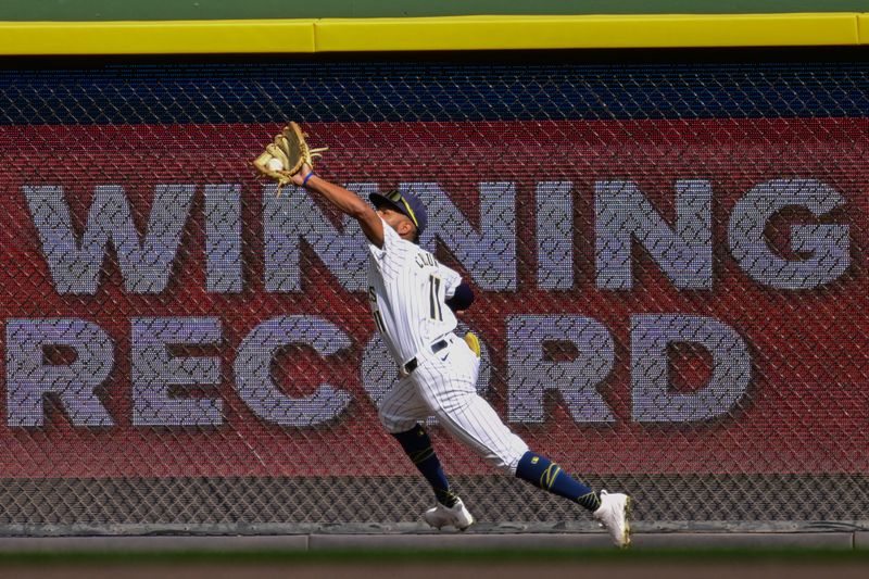 Sep 8, 2024; Milwaukee, Wisconsin, USA; Milwaukee Brewers right fielder Jackson Chourio (11) makes a running catch on ball hit by Colorado Rockies third baseman Ryan McMahon (not pictured) in the ninth inning at American Family Field. Mandatory Credit: Benny Sieu-Imagn Images