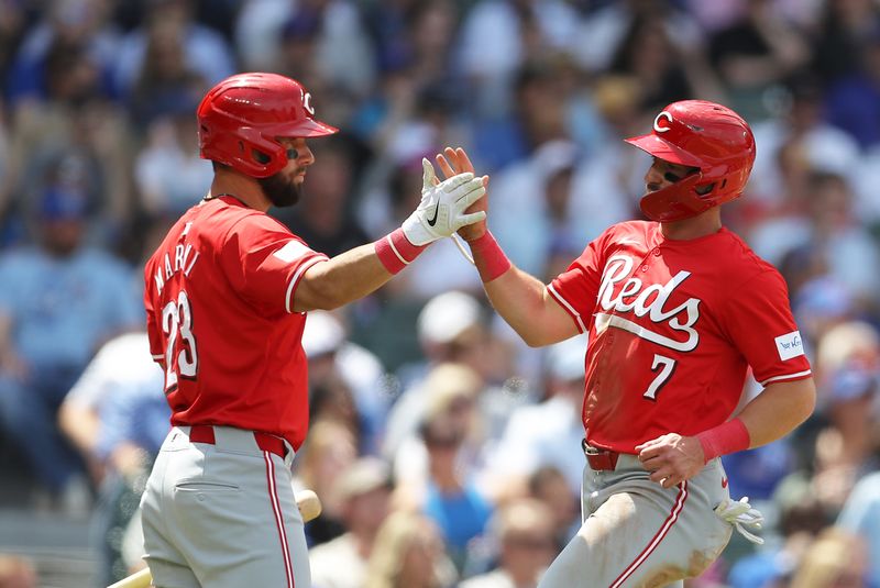 May 31, 2024; Chicago, Illinois, USA; Cincinnati Reds outfielder Spencer Steer (7) high fives Nick Martini (23) after scoring on a Jake Fraley (27) RBI single during the fourth inning against the Chicago Cubs at Wrigley Field. Mandatory Credit: Melissa Tamez-USA TODAY Sports