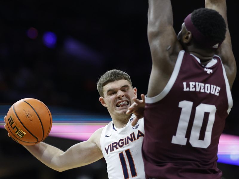 Nov 29, 2023; Charlottesville, Virginia, USA; Virginia Cavaliers guard Isaac McKneely (11) leaps to pass the ball as Texas A&M Aggies forward Wildens Leveque (10) defends in the second half at John Paul Jones Arena. Mandatory Credit: Geoff Burke-USA TODAY Sports