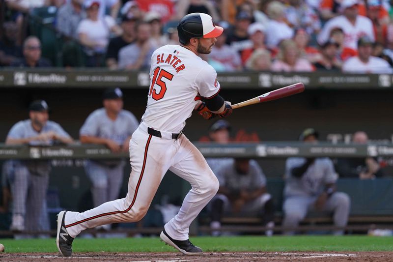 Sep 2, 2024; Baltimore, Maryland, USA; Baltimore Orioles outfielder Austin Slater (15) singles to drive in two runs during the sixth inning against the Chicago White Sox at Oriole Park at Camden Yards. Mandatory Credit: Mitch Stringer-USA TODAY Sports