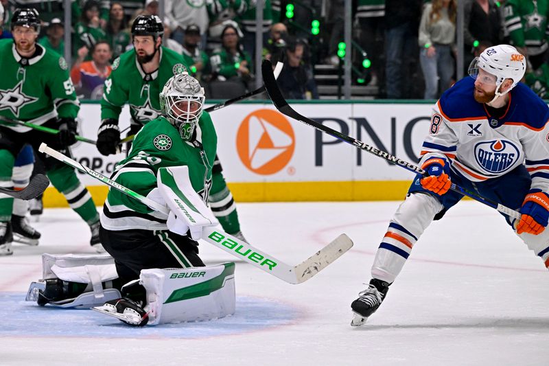 May 21, 2025; Dallas, Texas, USA; Dallas Stars goaltender Jake Oettinger (29) turns aside a shot by Edmonton Oilers right wing Connor Brown (28) during the third period in game one of the Western Conference Final of the 2025 Stanley Cup Playoffs at American Airlines Center. Mandatory Credit: Jerome Miron-Imagn Images