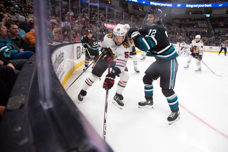 Oct 31, 2024; San Jose, California, USA; Chicago Blackhawks left winger Tyler Bertuzzi (59) controls the puck against the boards ahead of San Jose Sharks left winger William Eklund (72) during the second period at SAP Center at San Jose. Mandatory Credit: D. Ross Cameron-Imagn Images