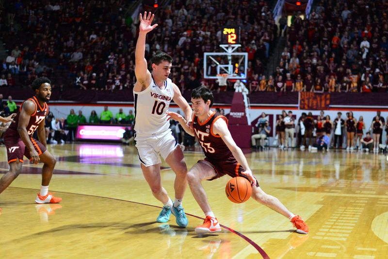 Feb 19, 2024; Blacksburg, Virginia, USA; Virginia Tech Hokies guard Michael Ward (33) drives with the ball as Virginia Cavaliers guard Taine Murray (10) defends during the second half at Cassell Coliseum. Mandatory Credit: Brian Bishop-USA TODAY Sports