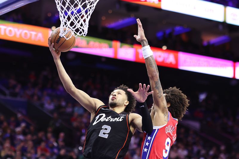 PHILADELPHIA, PENNSYLVANIA - DECEMBER 15: Cade Cunningham #2 of the Detroit Pistons shoots a lay up past Kelly Oubre Jr. #9 of the Philadelphia 76ers during the second quarter at the Wells Fargo Center on December 15, 2023 in Philadelphia, Pennsylvania. NOTE TO USER: User expressly acknowledges and agrees that, by downloading and or using this photograph, User is consenting to the terms and conditions of the Getty Images License Agreement. (Photo by Tim Nwachukwu/Getty Images)