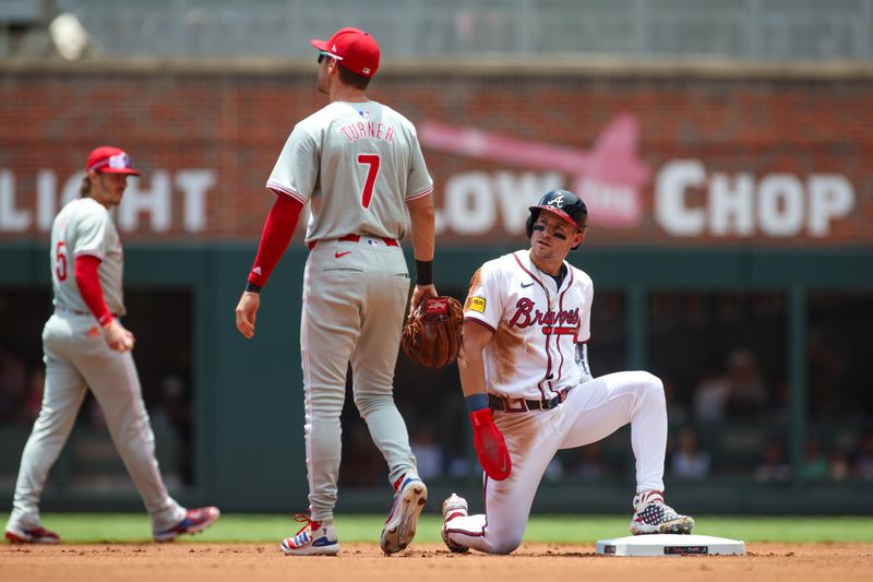 Jul 7, 2024; Atlanta, Georgia, USA; Atlanta Braves center fielder Jarred Kelenic (24) slides safely into second with a stolen base past the tag of Philadelphia Phillies shortstop Trea Turner (7) in the first inning at Truist Park. Mandatory Credit: Brett Davis-USA TODAY Sports
