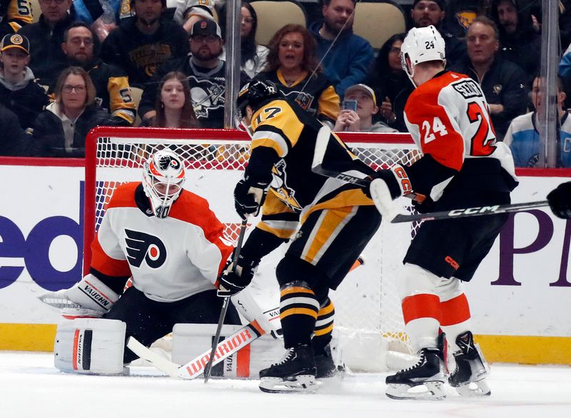 Feb 25, 2024; Pittsburgh, Pennsylvania, USA;  Pittsburgh Penguins right wing Bryan Rust (17) scores a goal against Philadelphia Flyers goaltender Cal Petersen (40) during the first period at PPG Paints Arena. Mandatory Credit: Charles LeClaire-USA TODAY Sports