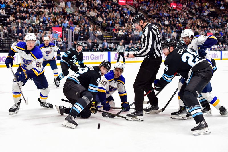 Jan 18, 2025; Salt Lake City, Utah, USA; Utah Hockey Club center Kevin Stenlund (82) and St. Louis Blues center Brayden Schenn (10) face-off during third period at the Delta Center. Mandatory Credit: Christopher Creveling-Imagn Images