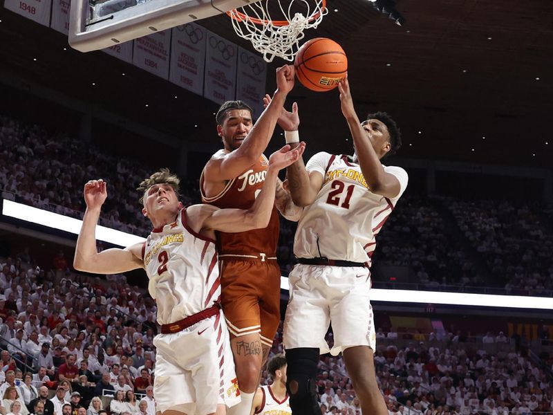 Jan 17, 2023; Ames, Iowa, USA; Iowa State Cyclones center Osun Osunniyi (21) and guard Caleb Grill (2) battle for a rebound with Texas Longhorns forward Timmy Allen (0) during the second half at James H. Hilton Coliseum. Mandatory Credit: Reese Strickland-USA TODAY Sports