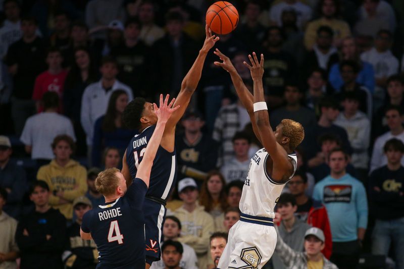 Jan 20, 2024; Atlanta, Georgia, USA; Virginia Cavaliers guard Ryan Dunn (13) blocks the shot of Georgia Tech Yellow Jackets guard Kowacie Reeves Jr. (14) in the first half at McCamish Pavilion. Mandatory Credit: Brett Davis-USA TODAY Sports