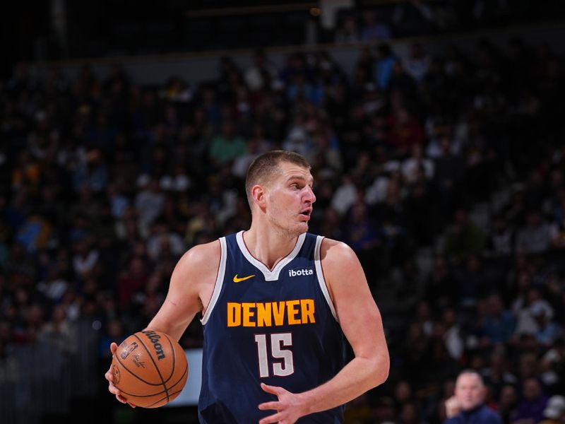 DENVER, CO - MARCH 25: Nikola Jokic #15 of the Denver Nuggets handles the ball during the game against the Memphis Grizzlies on March 25, 2024 at the Ball Arena in Denver, Colorado. NOTE TO USER: User expressly acknowledges and agrees that, by downloading and/or using this Photograph, user is consenting to the terms and conditions of the Getty Images License Agreement. Mandatory Copyright Notice: Copyright 2024 NBAE (Photo by Bart Young/NBAE via Getty Images)