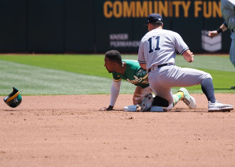 Jun 29, 2023; Oakland, California, USA; Oakland Athletics second baseman Tony Kemp (5) steals second base against New York Yankees shortstop Anthony Volpe (11) during the first inning at Oakland-Alameda County Coliseum. Mandatory Credit: Kelley L Cox-USA TODAY Sports