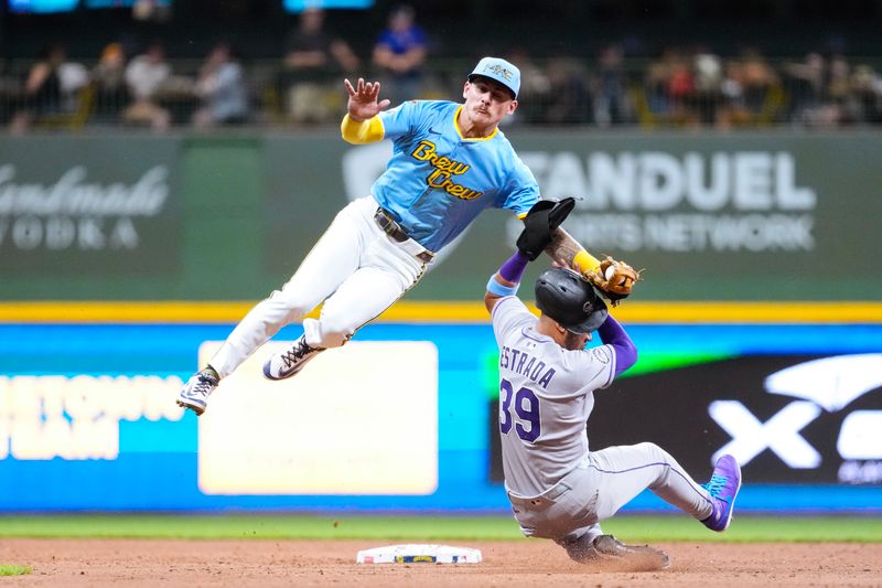 Jun 27, 2025; Milwaukee, Wisconsin, USA;  Colorado Rockies second baseman Thairo Estrada (39) is tagged out but Milwaukee Brewers shortstop Joey Ortiz (3) while trying to steal second base during the seventh inning at American Family Field. Mandatory Credit: Jeff Hanisch-Imagn Images
