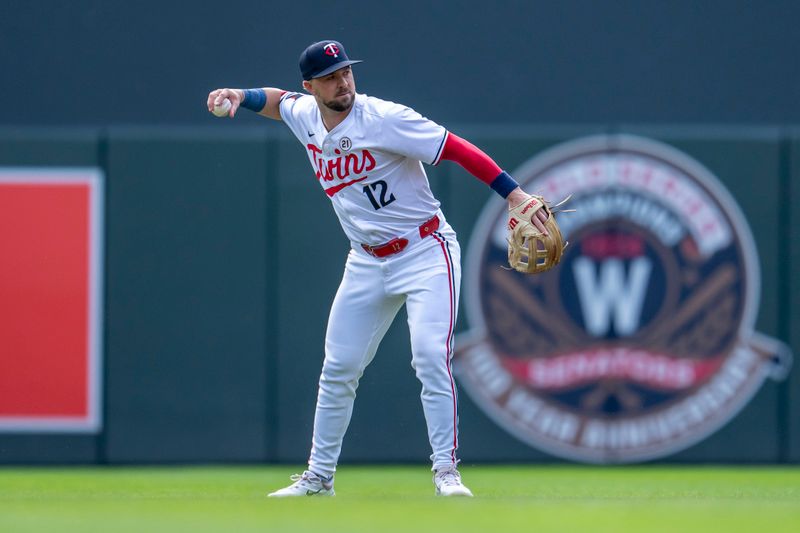Sep 15, 2024; Minneapolis, Minnesota, USA; Minnesota Twins second baseman Kyle Farmer (12) throws the ball to first base for an out against the Cincinnati Reds in the first inning at Target Field. Mandatory Credit: Jesse Johnson-Imagn Images