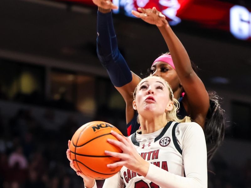 Feb 4, 2024; Columbia, South Carolina, USA; South Carolina Gamecocks forward Chloe Kitts (21) drives past Ole Miss Rebels guard Marquesha Davis (2) in the first half at Colonial Life Arena. Mandatory Credit: Jeff Blake-USA TODAY Sports