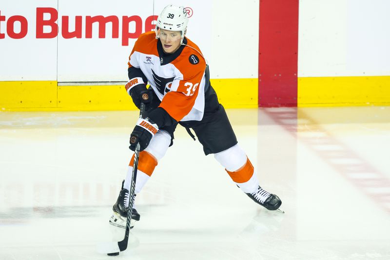 Dec 31, 2025; Calgary, Alberta, CAN; Philadelphia Flyers right wing Matvei Michkov (39) controls the puck during the warmup period against the Calgary Flames at Scotiabank Saddledome. Mandatory Credit: Sergei Belski-Imagn Images