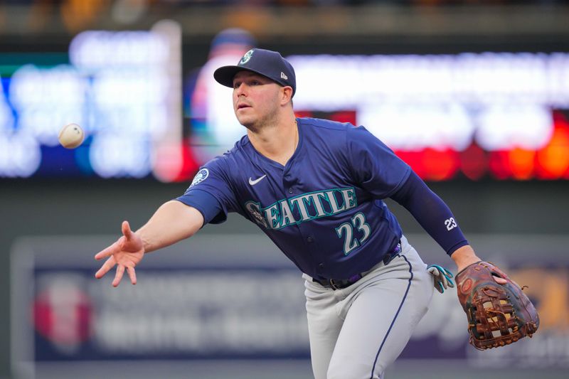 May 7, 2024; Minneapolis, Minnesota, USA; Seattle Mariners first baseman Ty France (23) throws to first base against the Minnesota Twins in the fourth inning at Target Field. Mandatory Credit: Brad Rempel-USA TODAY Sports