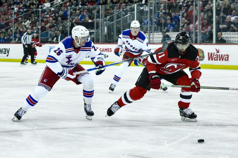 Feb 22, 2024; Newark, New Jersey, USA; New Jersey Devils defenseman Jonas Siegenthaler (71) and New York Rangers left wing Jimmy Vesey (26) pursue the puck during the first period at Prudential Center. Mandatory Credit: John Jones-USA TODAY Sports