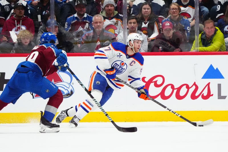 Nov 30, 2024; Denver, Colorado, USA; Colorado Avalanche defenseman Samuel Girard (49) chases down Edmonton Oilers center Connor McDavid (97) in the second period at Ball Arena. Mandatory Credit: Ron Chenoy-Imagn Images