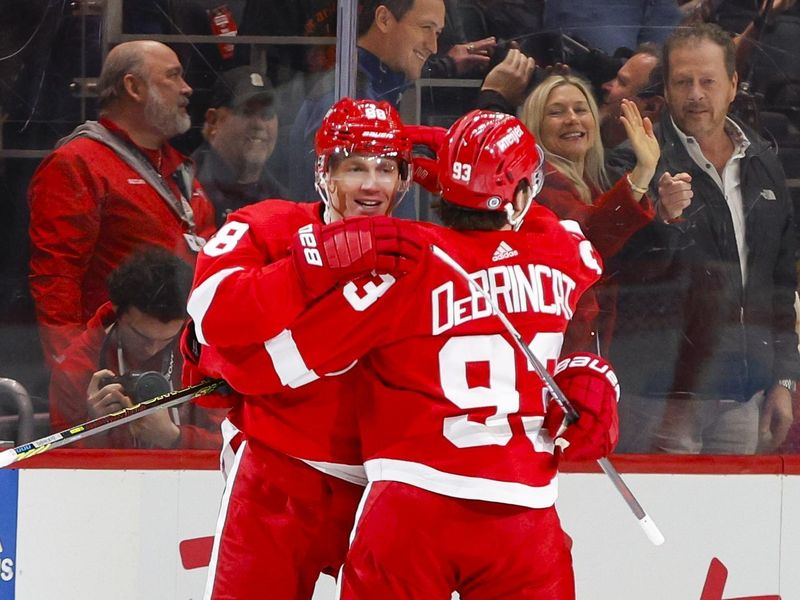 Dec 9, 2023; Detroit, Michigan, USA; Detroit Red Wings right wing Patrick Kane (88) celebrates his goal scored with right wing Alex De Brincat (93) during the first period at Little Caesars Arena. Mandatory Credit: Brian Bradshaw Sevald-USA TODAY Sports