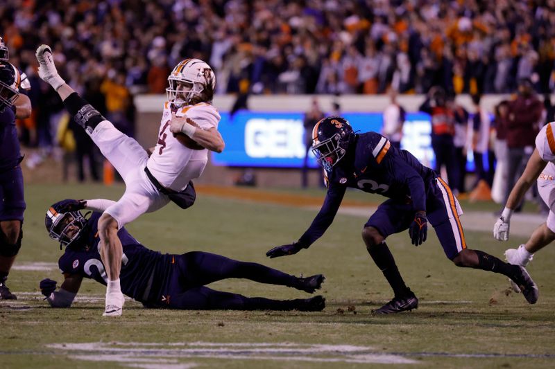 Nov 27, 2021; Charlottesville, Virginia, USA; Virginia Tech Hokies quarterback Connor Blumrick (4) is upended while running with the ball by Virginia Cavaliers free safety Joey Blount (29) during the fourth quarter at Scott Stadium. Mandatory Credit: Geoff Burke-USA TODAY Sports