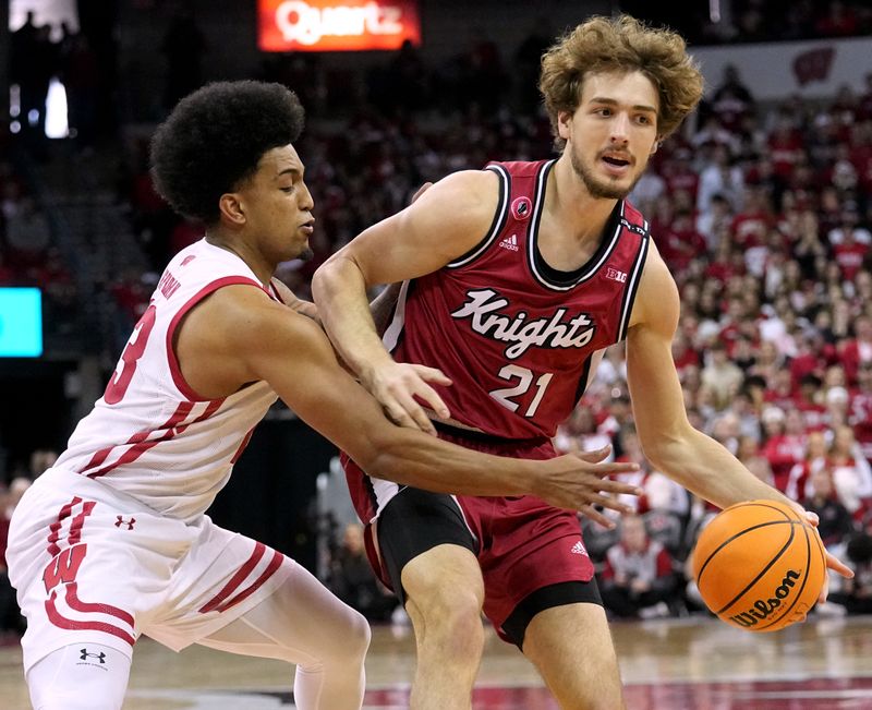 Feb. 18, 2023; Madison, WI, USA; Wisconsin Badgers guard Chucky Hepburn (23) fouls Rutgers Scarlet Knights forward Dean Reiber (21) during the first half at the Kohl Center. Mandatory Credit: Mark Hoffman-USA TODAY Sports