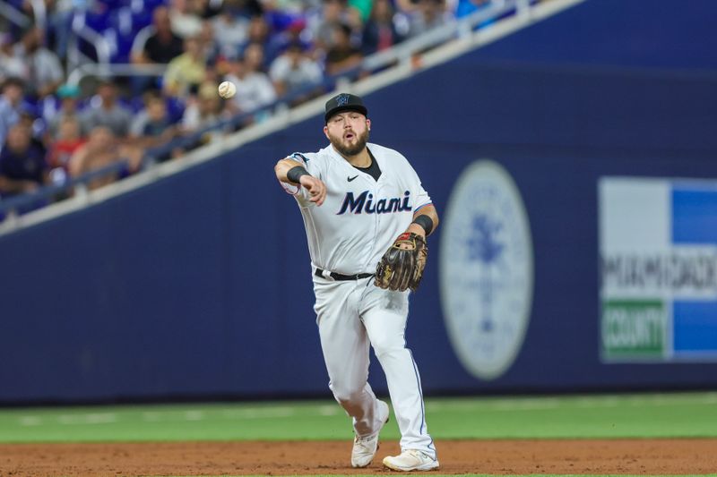 Aug 15, 2023; Miami, Florida, USA; Miami Marlins third baseman Jake Burger (36) throws to first and retires Houston Astros center fielder Jake Meyers (not pictured) during the third inning at loanDepot Park. Mandatory Credit: Sam Navarro-USA TODAY Sports