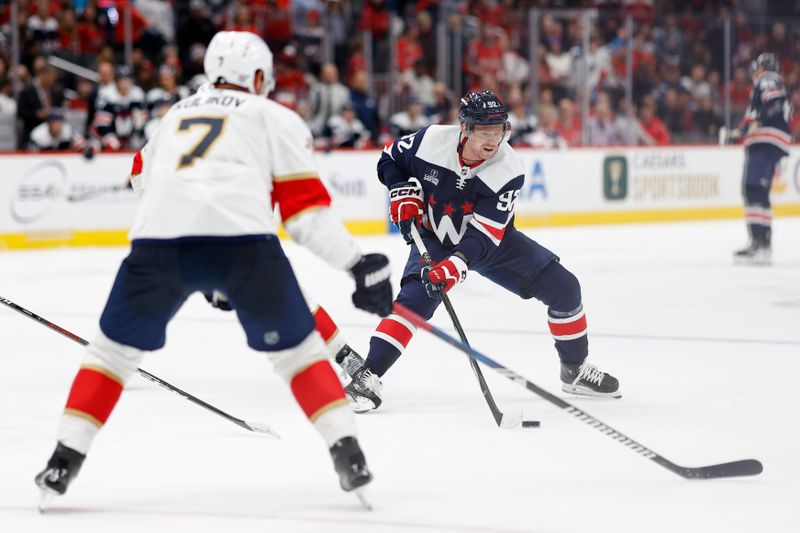 Nov 8, 2023; Washington, District of Columbia, USA;Washington Capitals center Evgeny Kuznetsov (92) skates with the puck as Florida Panthers defenseman Dmitry Kulikov (7) defends in the third period  at Capital One Arena. Mandatory Credit: Geoff Burke-USA TODAY Sports