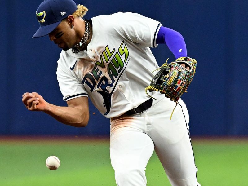 Aug 9, 2024; St. Petersburg, Florida, USA; Tampa Bay Rays second baseman Christopher Morel (24) misplays a ground ball in the fifth inning against the Baltimore Orioles at Tropicana Field. Mandatory Credit: Jonathan Dyer-USA TODAY Sports