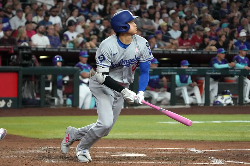 May 11, 2025; Phoenix, Arizona, USA; Los Angeles Dodgers Shohei Ohtani (17) hits an RBI single against the Arizona Diamondbacks in the sixth inning at Chase Field. Mandatory Credit: Rick Scuteri-Imagn Images