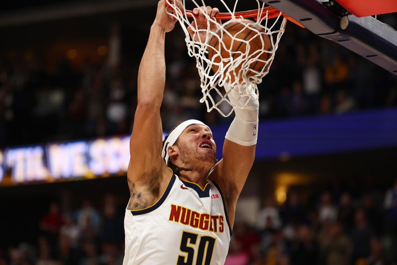 DENVER, COLORADO - DECEMBER 25: Aaron Gordon #50 of the Denver Nuggets dunks against the against the Golden State Warriors during the first half at Ball Arena on December 25, 2023 in Denver, Colorado. NOTE TO USER: User expressly acknowledges and agrees that, by downloading and/or using this Photograph, user is consenting to the terms and conditions of the Getty Images License Agreement. (Photo by Jamie Schwaberow/Getty Images)