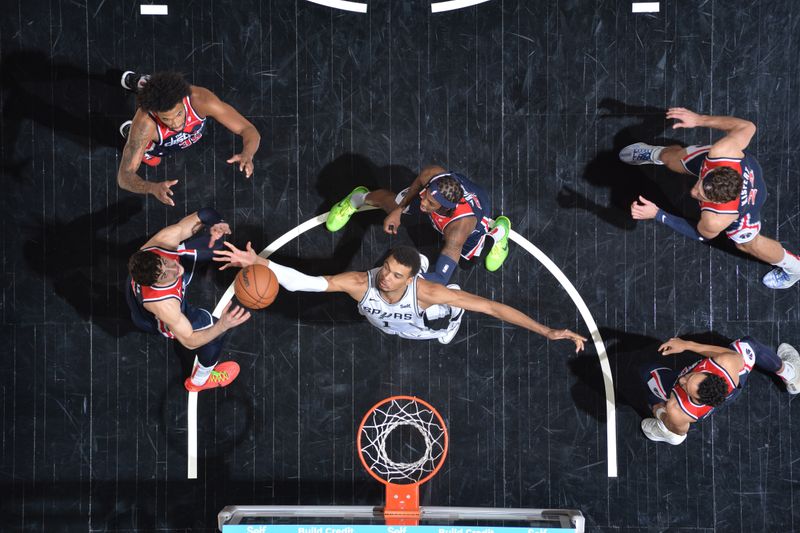 SAN ANTONIO, TX - JANUARY 29:  Victor Wembanyama #1 of the San Antonio Spurs rebounds the ball during the game  against the Washington Wizards on January 29, 2024 at the Frost Bank Center in San Antonio, Texas. NOTE TO USER: User expressly acknowledges and agrees that, by downloading and or using this photograph, user is consenting to the terms and conditions of the Getty Images License Agreement. Mandatory Copyright Notice: Copyright 2024 NBAE (Photos by Michael Gonzales/NBAE via Getty Images)