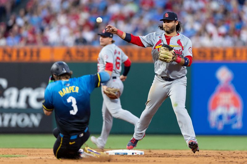 May 31, 2024; Philadelphia, Pennsylvania, USA; St. Louis Cardinals shortstop Brandon Crawford (35) throws for a double play after tagging out Philadelphia Phillies first base Bryce Harper (3) at Citizens Bank Park. Mandatory Credit: Bill Streicher-USA TODAY Sports