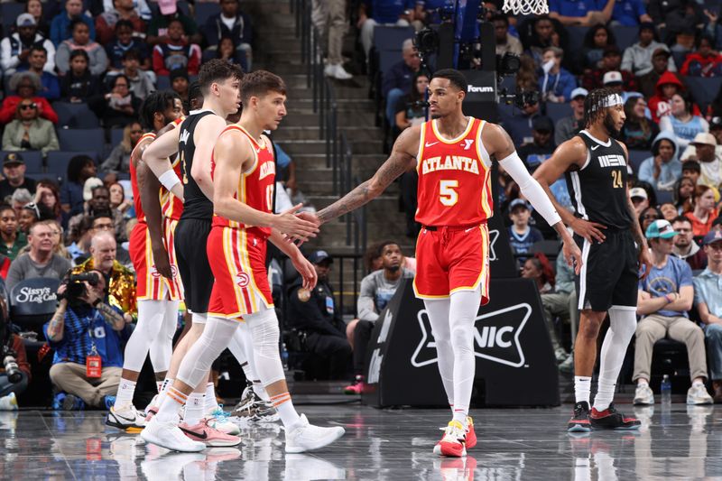 MEMPHIS, TN - MARCH 8: Dejounte Murray #5 and Bogdan Bogdanovic #13 of the Atlanta Hawks high five during the game against the Memphis Grizzlies on March 8, 2024 at FedExForum in Memphis, Tennessee. NOTE TO USER: User expressly acknowledges and agrees that, by downloading and or using this photograph, User is consenting to the terms and conditions of the Getty Images License Agreement. Mandatory Copyright Notice: Copyright 2024 NBAE (Photo by Joe Murphy/NBAE via Getty Images)