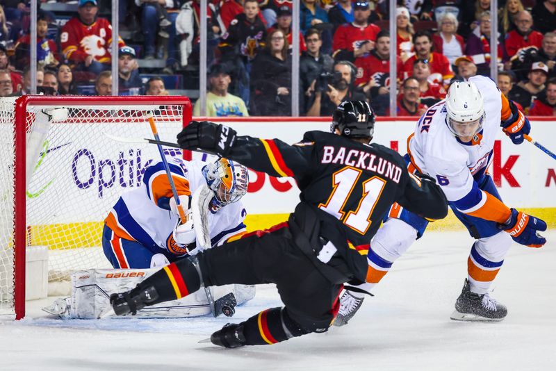 Nov 18, 2023; Calgary, Alberta, CAN; New York Islanders goaltender Ilya Sorokin (30) makes a save against Calgary Flames center Mikael Backlund (11) during the second period at Scotiabank Saddledome. Mandatory Credit: Sergei Belski-USA TODAY Sports