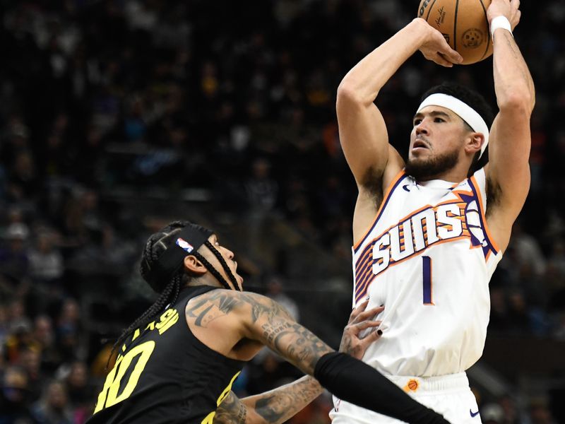 SALT LAKE CITY, UTAH - NOVEMBER 19: Devin Booker #1 of the Phoenix Suns shoots the ball against Jordan Clarkson #00 of the Utah Jazz in double overtime of a game at Delta Center on November 19, 2023 in Salt Lake City, Utah. NOTE TO USER: User expressly acknowledges and agrees that, by downloading and or using this photograph, User is consenting to the terms and conditions of the Getty Images License Agreement. (Photo by Alex Goodlett/Getty Images)