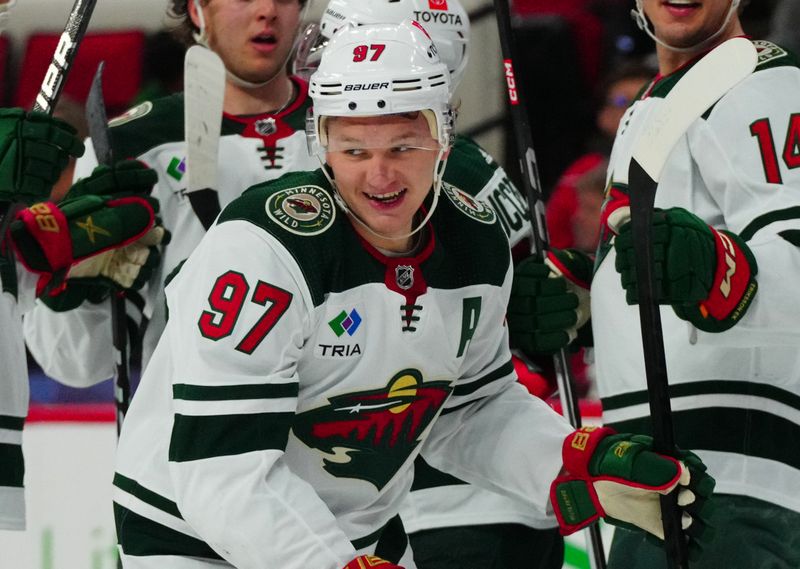 Jan 21, 2024; Raleigh, North Carolina, USA;  Minnesota Wild left wing Kirill Kaprizov (97) scores a goal against the Carolina Hurricanes during the second period at PNC Arena. Mandatory Credit: James Guillory-USA TODAY Sports