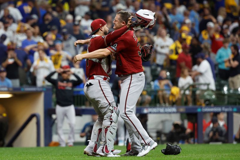 Oct 4, 2023; Milwaukee, Wisconsin, USA; Arizona Diamondbacks relief pitcher Paul Sewald (38) and catcher Jose Herrera (11) celebrate after winning against the Milwaukee Brewers in game two of the Wildcard series for the 2023 MLB playoffs at American Family Field. Mandatory Credit: Kamil Krzaczynski-USA TODAY Sports