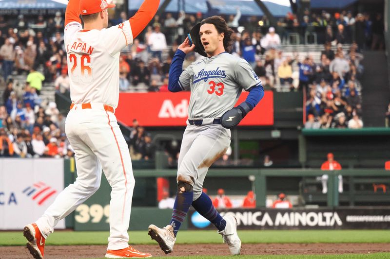 May 14, 2024; San Francisco, California, USA; Los Angeles Dodgers center fielder James Outman (33) reaches third base against San Francisco Giants third baseman Matt Chapman (26) during the third inning at Oracle Park. Mandatory Credit: Kelley L Cox-USA TODAY Sports