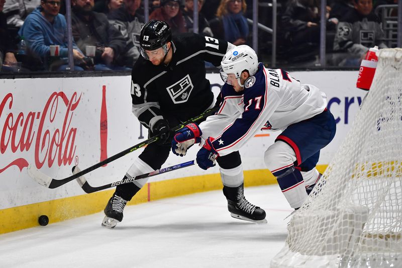 Mar 16, 2023; Los Angeles, California, USA; Columbus Blue Jackets defenseman Nick Blankenburg (77) plays for the puck against Los Angeles Kings right wing Gabriel Vilardi (13) during the second period at Crypto.com Arena. Mandatory Credit: Gary A. Vasquez-USA TODAY Sports